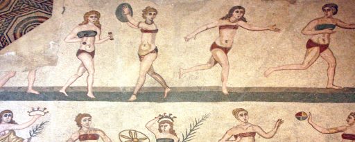 Close up of the Roman mosaic at Piazza Armerina in Sicily showing women in bikinis running and playing sports
