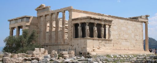 Wide shot of the Erectheion on the Acropolis with blue skies in Athens Greece