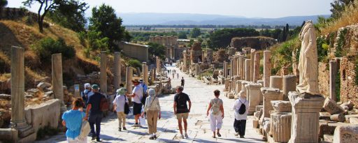 Small group walking down the ancient Curetes street towards the library of Celsus at the archaeological site of Ephesus in Turkey