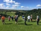 Tour guests enjoying the views from the Roman fort at Birdoswald on Hadrian's Wall in England
