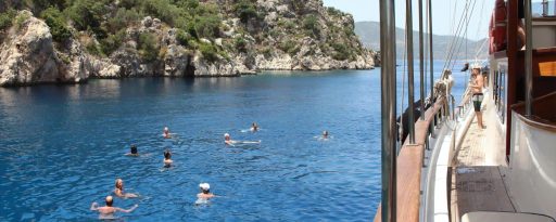 Guests swimming in turquoise waters from a gulet during a cruise on the coast of Turkey