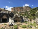 Rock-cut chamber tombs and the acropolis at the ancient city of Pinara in Turkey