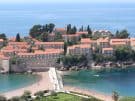 The island of Sveti Stefan accessed by a causeway flanked by sandy beaches