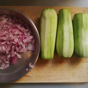 Preparing for step 2: Onions chopped fine, courgettes/zucchini peeled.
