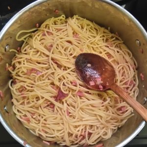 Step 4: what, no image for step 3?!? No, we thought you don't need an illustration of draining pasta. Here, we're mixing pasta and bacon. A stirring sight!