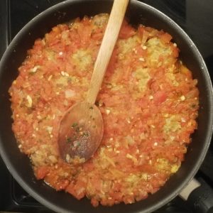 Step 7: the tomato sauce has been poured over the polpette, and they're heating up together.