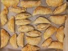 Kalitsounia savoury pies on a baking tray in Crete, Greece