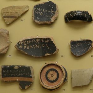 Ostraka in the Agora Museum. Inscribed with the names of famous Athenians, these potsherds were used in the ostracism, to determine who should be banished for being too ambitious and thus endangering the fledgling democracy.