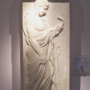 The Eupheros stele in the Kerameikos Museum. It shows the deceased, in contemplation, marked as an athlete by the strigil he is holding.
