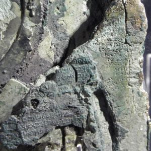 A detail of the famous Antikythera Mechanism, a Hellenistic calendrical calculator, ca 125 BC(?), with one of the gears and an inscription visible. National Archaeological Museum.