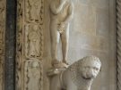 Sculpture of Adam and other architectural details by the entrance to the cathedral of Trogir in Croatia