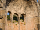 The apse and semi dome of Church 2 bathed in golden sunlight on Gemiler island in Turkey