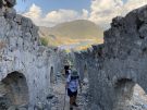 People walking in the so-called processional corridor up towards the main church on the summit of Gemiler island in Turkey