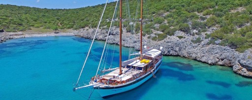 Aerial top shot of a gulet in a cove on turquoise seas on the coast of Turkey