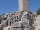 Lycian house tomb facades, overlooked by a pillar tomb, at Xanthos in Turkey