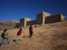 walkers approaching a reconstructed section of the mudbrick-on-stone city walls at Hattusha, capital of the Hittite Empire in Turkey