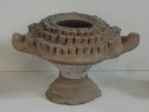 Clay objects like this one are typical finds at Eleusis and at other sanctuaries of Demeter and Kore. While some scholars see them as receptacles for offerings, they are more likely multi-flamed lamps, perhaps connected with the Mysteries.