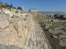 Rock-cut steps and massive foundations indicate the impressive size of the Telesterion