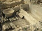 Detail of the Hellensistic bathhouse, with clay heating pipes, a basin and a built-in pool.