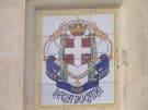 The insignia of Mussolini's Italy, on painted tiles still attached to one of Lakki's public buildings.