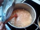 Syrup being stirred into the semolina mixture to make Greek halva