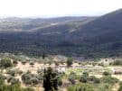View over the central part of ancient Messene, with the Asklipieion at the centre, the stadium behind, and the shores of the Gulf of Kalamata in the background, in Greece.