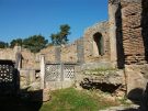 The interior of the Workshop of Pheidias, where the moulds were found. The limestone foundations belong to the poriginal 5th century BC structure, the brick walls and internal fittings to the 5th century (?) AD church. (Image by Wikimedia Commons user Joanbanjo).