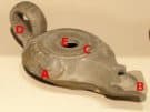 An ancient oil lamp from the Antikythera Shipwreck with its main features indicated