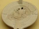 A Roman oil lamp from the Agora of Athens depicting Leda's encounter with Zeus disguised as a swan