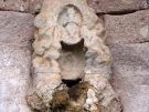 Waterspout of a fountain in the Asklepieion of Kos in Greece decorated with a relief of Pan playing his pipes
