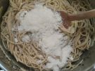 stirring cheese and pasta water into the pasta