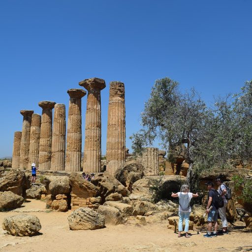 Visitors exploring one of the ancient Greek temples at Agrigento in Sicily