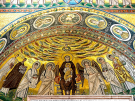 A golden Byzantine mosaic in the apse of the Euphrasian Basilica, featuring the Virgin Mary enthroned with the Christ Child. She is flanked by angels and local saints, including Bishop Euphrasius holding a model of the church. The arch above features medallions of female saints and the Agnus Dei (Lamb of God) at the center.