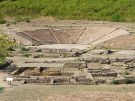 The excavated stone tiers of the Hellenistic Greek theater and foreground agora foundations at the Parco Archeologico di Morgantina in Aidone, Sicily.