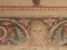 A 4th-century BC Macedonian tomb painting from Aineia, Greece, now in the Archaeological Museum of Thessaloniki. It features a faded female face centered within an elaborate decorative border of floral scrolls, acanthus leaves, and a red geometric upper band.