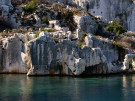 Partially submerged stone walls, doorways, and foundations of the ancient Lycian city Dolichiste on the rocky coastline of Kekova Island, Turkey.