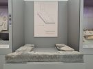 View of the throne of Tiryns in Greece. A low-standing single course of battered and fractured oblong blocks forming a Π or staple-shape at the Athens National Museum.
