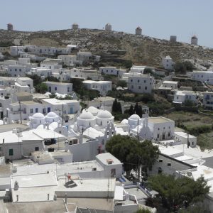 A view from the castle, taking in the tree-shaded central square and main church, as well as the traditional windmills (in ruins) on the ridge separating the Chora from the island's southern coast.